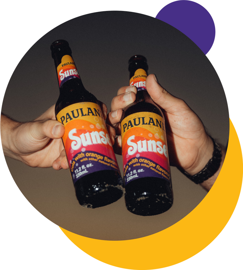 two bottles of Paulaner Sunset spezi soda